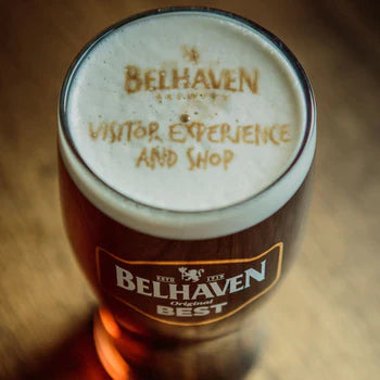 Glass of Belhaven Best beer with the Belhaven Brewery logo visible in the head